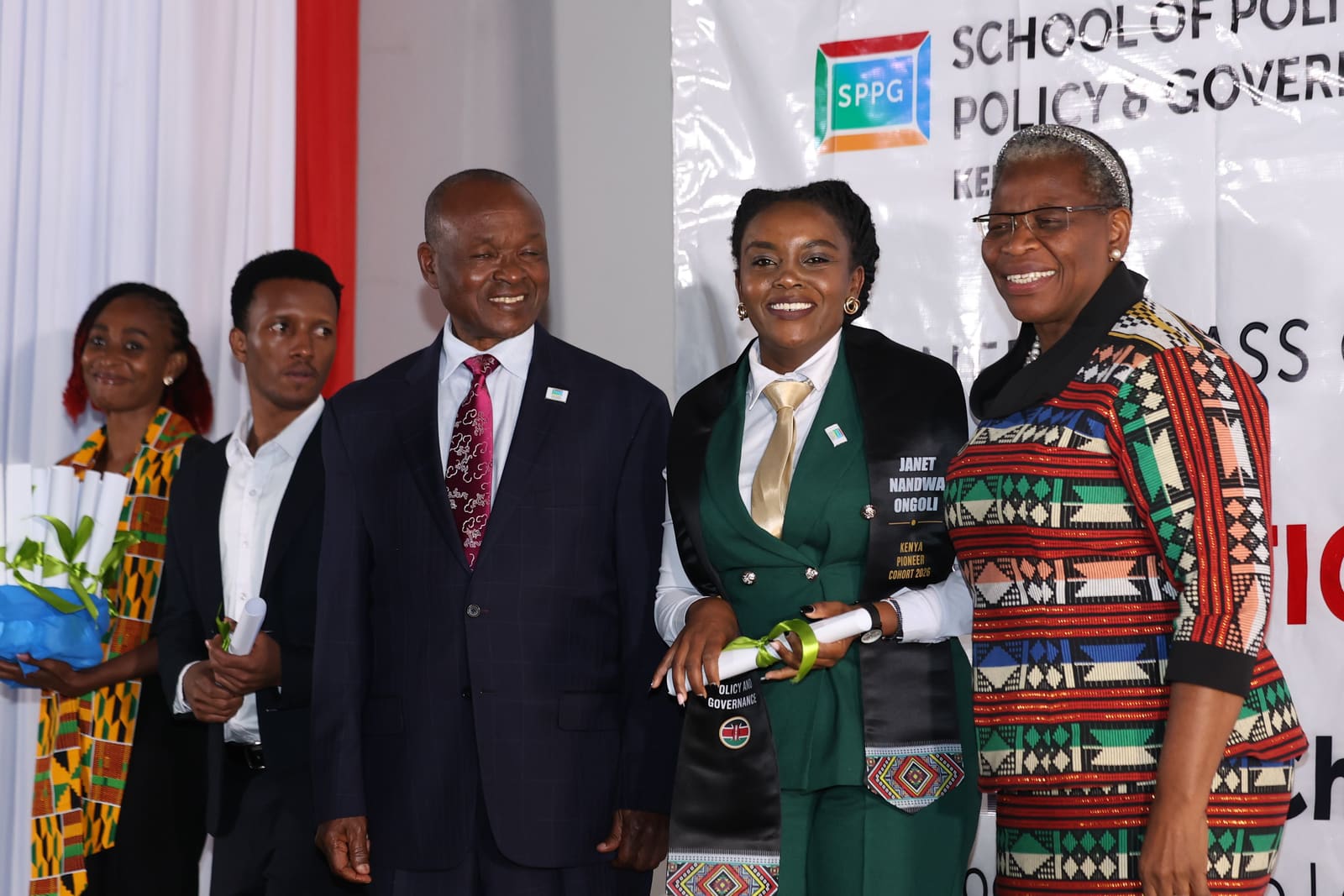 A Kenyan graduate receiving her certificate on stage